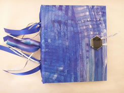 Blue paint wash with custom button on hand-made book