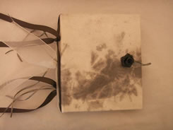 Gray and white suede looking finish with hand-made black rose button