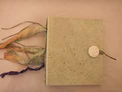 Tan hand-made paper with unique custom button on hand-made book